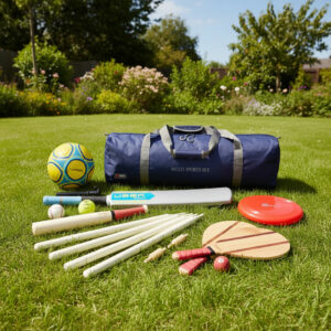 uber-games-multi-sports-set-1 - Masters Traditional Games Blue multi-sports bag on a sunny lawn with cricket bats, balls, and a red disc nearby.