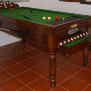 bar-billiards-jelkes-north-carolina-usa-1 - Masters Traditional Games - Masters Traditional Games Wooden billiards/pool table with green felt in a tiled room, cues and balls arranged on the surface.
